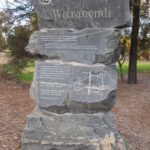 Image: A sculpture comprised of four large stones stacked atop one another. The word ‘Wirranendi’ is inscribed in the top stone, along with additional informative text