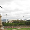 Image: Bronze statue of man pointing over stadium