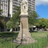 Image: stone statue of man on stone pillar