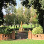 Image: stone sculpture of standing woman in garden