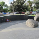 Image: bronze sculpture of man and woman in uniform, slate pavers in foreground