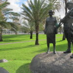 Image: bronze sculpture of man and woman in uniform