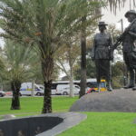 Image: bronze sculpture of man and woman in uniform