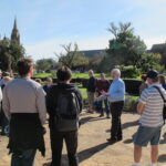 Image: people standing in front of large stone cross