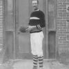 Image: Black and white photo of man holding football