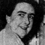 Newspaper photo, head and shoulders of woman.