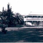 Image: street scene showing woman in front of two story building