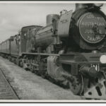 Image: Front view of a long train which has South Australian Jubilee train displayed on the front panel