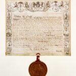 Image: Old document in browning ink with large wax seal attached at bottom