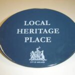 Image: blue plaque with logo and text