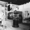 Black and white image of old museum display showing large wooden plinth with staircase on top.