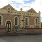 Image: Colour photo of a historic brickwork building.