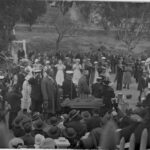 Various officials and members of public mill about whilst the BCLB and Navy Band perform standing amongst them