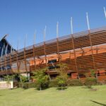 Image: Large curved building front clad in wooden slats