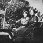 Image: two women pose for photograph in a motor car