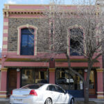 Image: two story stone building with large windows