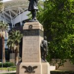 Image: Bronze statue of a man atop a granite pillar