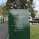 Image: Green signpost with gold writing