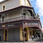 Image: two story building with ornate veranda front