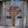 Image: enshrined memorial cross from the Siege of Tobruk, accompanied by informational plaques