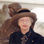 Image: woman in front of sculpture of herself