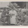 Image: A woman and three men sitting in a garden