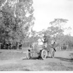 Image: old open top car on dirt road