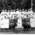 Image: group photo women with instruments, men in uniform