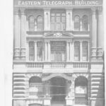 Image: Photograph of the front of a building. It has several columns and reads "Eastern Telegraph Building"