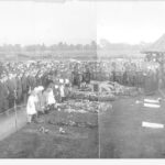 Image: large crowd gathered around coffin covered in flag