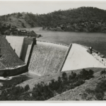 Image: Black and white photograph of dam and reservoir, before completion, circa 1938