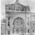 Image: large building with ornate arched entrance