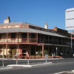 Image: A two-storey Victorian-era building with the words ‘Railway Hotel, 1856’ painted just below the roof