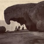 Image: people in front of large rock formation