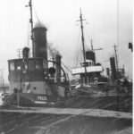 Image: A line of three tugboats tied up at a wharf. The tug in front has the name ‘Yelta’ painted on its bow