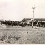 Image: A massive iron cylinder with the words ‘Brighton Cement’ painted on its side is pulled by several horses