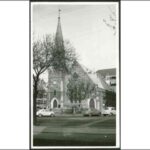 Image: three cars parked outside stone church