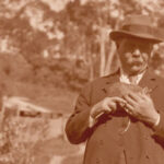 Image: Man in 1920's attire holding a possum