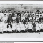 Image: girls and their teacher in early 20th century dresses