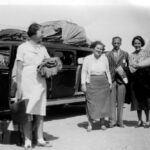 Image: Group of people standing in front of a bus