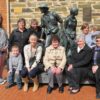 Image: family group pose with sculpture