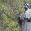 Bronze statue of standing man wearing robes