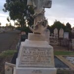 Image: large stone cross on stone base in graveyard