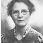 Image: Portrait photograph of a woman wearing glasses