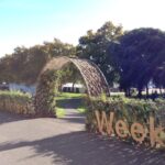 Image: arch at entrance to garden with pathway down grassed slope